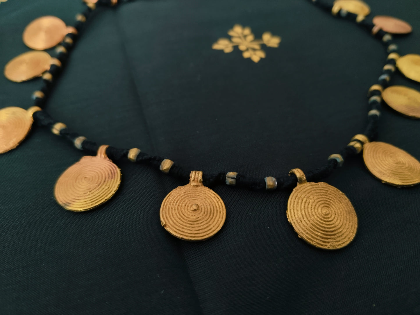 Spiral brass disk necklace