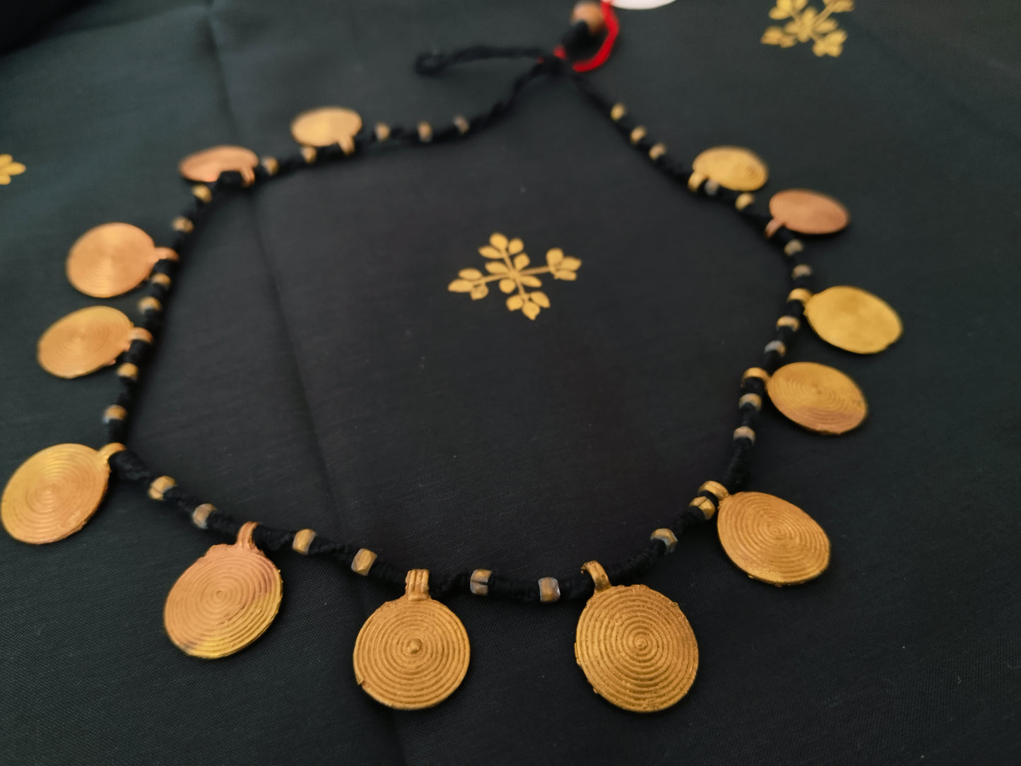 Spiral brass disk necklace
