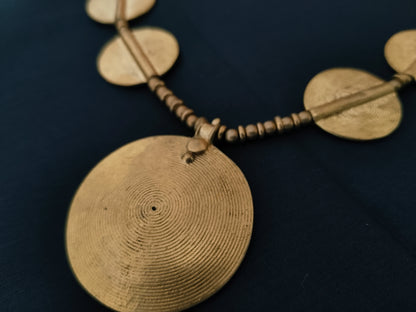 Sun pendant with beads and small brass disks